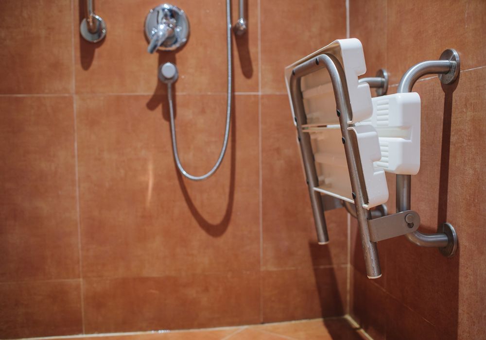 Folded shower seat inside a tiled shower