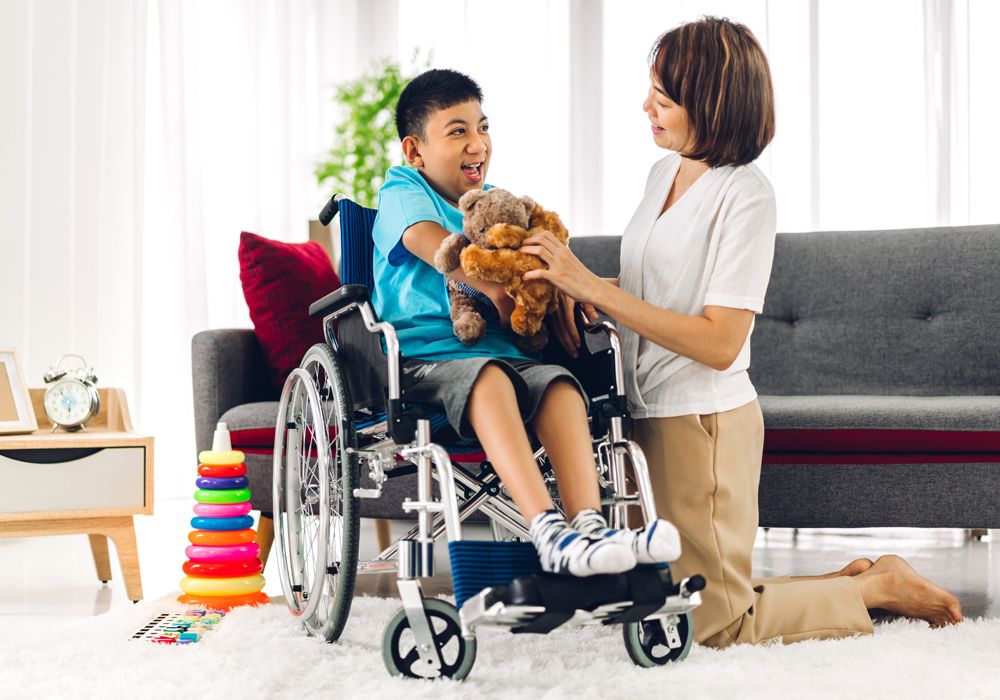 disabled boy in wheelchair looking at mother in kitchen